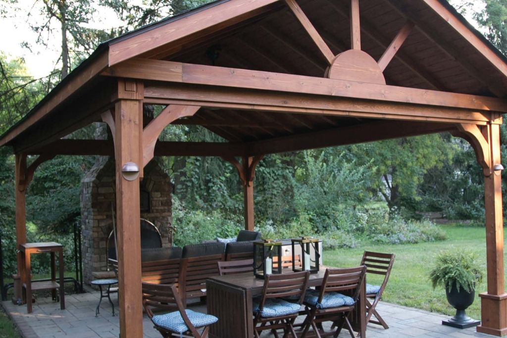 dark wood grill pavilion with fireplace and dining area